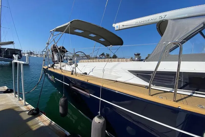 Slide: The Image of 2013 Jeanneau 57 yacht docked at marina under clear blue sky. - 8