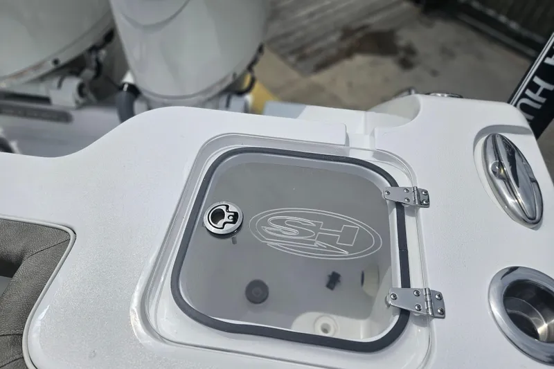 Slide: The Image of 2025 Sea Hunt Gamefish 27 Forward Seating boat detail with logo on hatch. - 10
