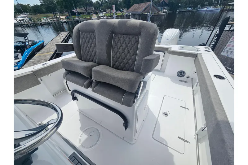 Slide: The Image of 2025 Sea Hunt Gamefish 27 boat with forward seating and plush gray upholstery. - 21
