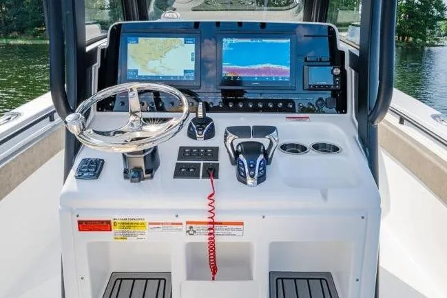 Slide: The Image of 2026 Sea Hunt Gamefish 27 Forward Seating dashboard with advanced navigation and control systems. - 23