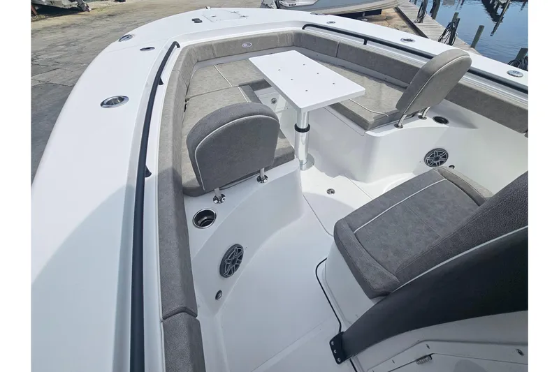 Slide: The Image of 2025 Sea Hunt Gamefish 27 Forward Seating with gray cushions and a white table. - 27