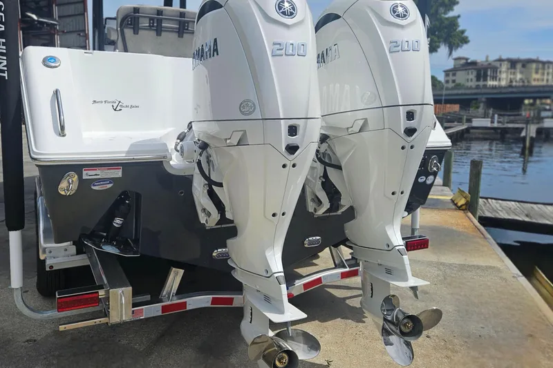 Slide: The Image of 2025 Sea Hunt Gamefish 27 with twin Yamaha 200 engines at a dockside location. - 4