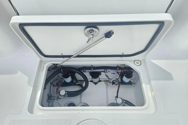 Slide: The Image of 2025 Sea Hunt Gamefish 27 Forward Seating boat compartment with visible wiring and components. - 9