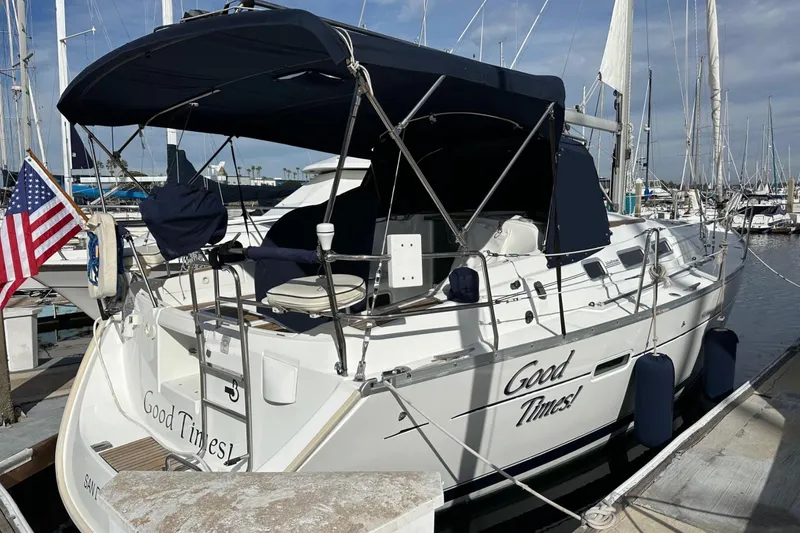 Slide: The Image of 2005 Beneteau Oceanis Clipper 373 sailboat docked, featuring "Good Times" name and American flag. - 1