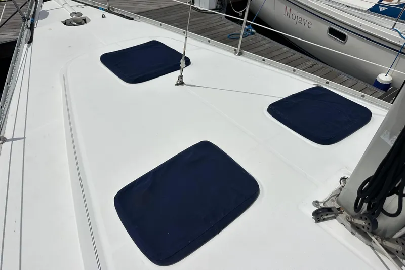 Slide: The Image of 2005 Beneteau Oceanis Clipper 373 deck with blue hatch covers at marina. - 10