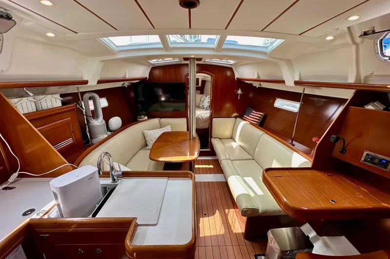 Slide: The Image of Interior of 2005 Beneteau Oceanis Clipper 373 yacht with elegant wood finish and cozy seating. - 14