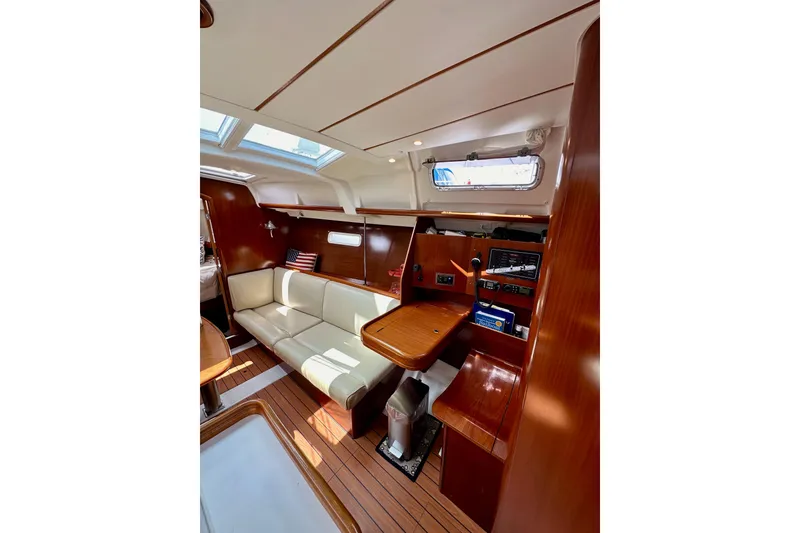 Slide: The Image of Interior of 2005 Beneteau Oceanis Clipper 373 sailboat with wood finish and seating area. - 15