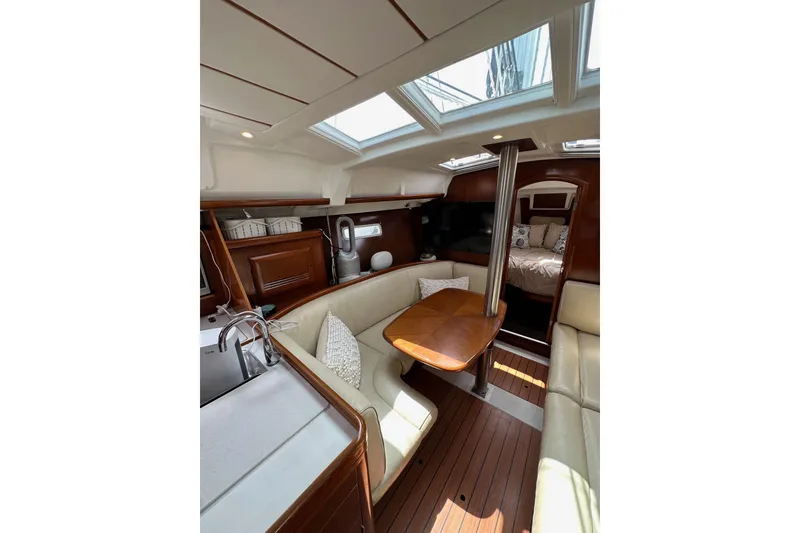 Slide: The Image of Interior of 2005 Beneteau Oceanis Clipper 373 yacht with cozy seating and wooden finishes. - 16