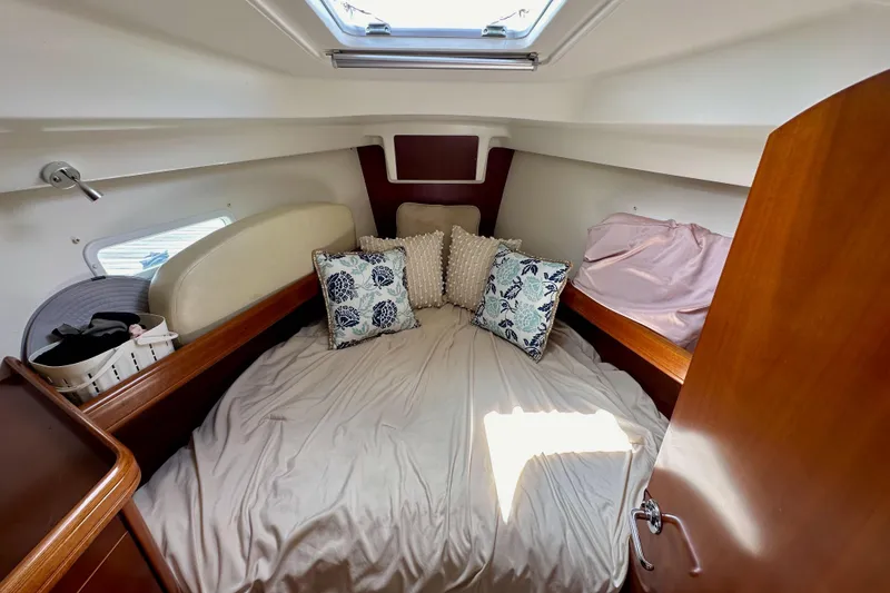Slide: The Image of Cozy cabin interior of 2005 Beneteau Oceanis Clipper 373 sailboat with pillows and bedding. - 18