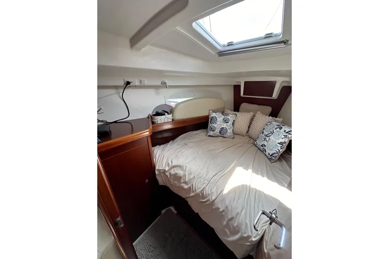 Slide: The Image of Cozy cabin interior of 2005 Beneteau Oceanis Clipper 373 with plush bedding and natural light. - 19