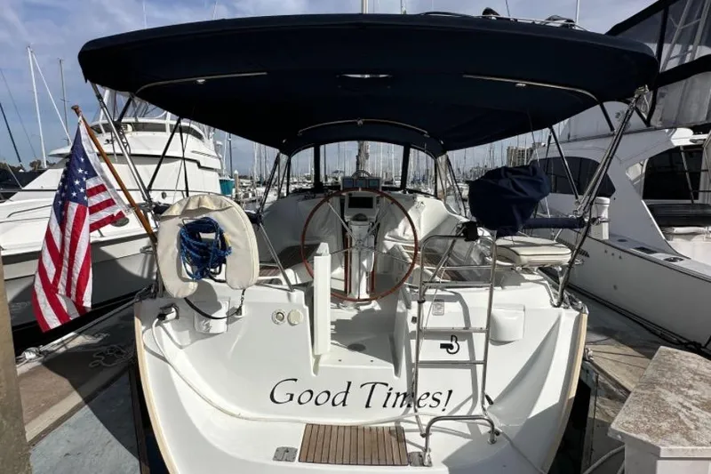 Slide: The Image of 2005 Beneteau Oceanis Clipper 373 sailboat docked, featuring "Good Times" text and American flag. - 2