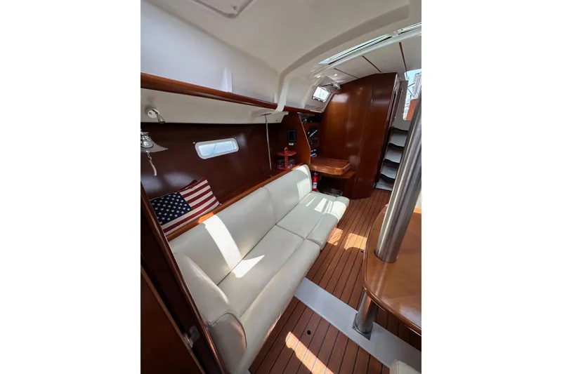 Slide: The Image of Interior of 2005 Beneteau Oceanis Clipper 373 with white seating and wooden finishes. - 20