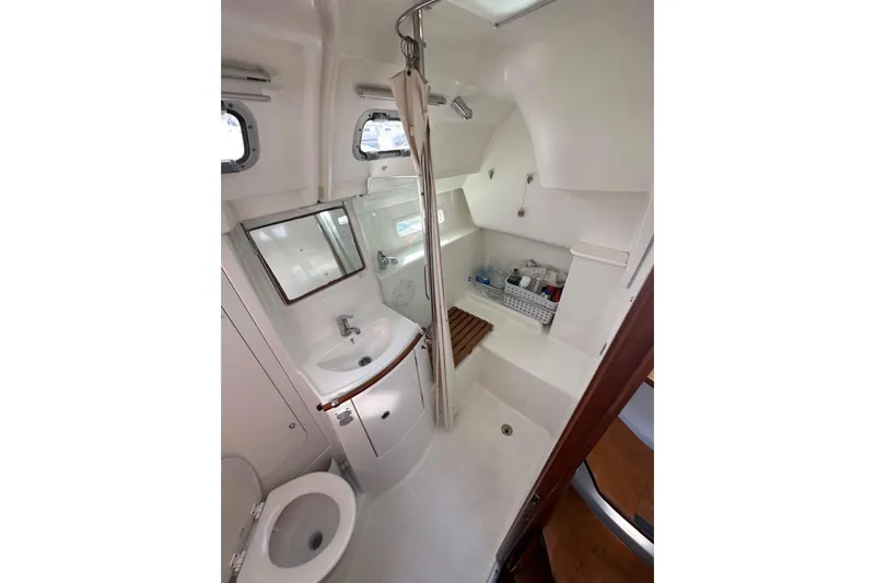 Slide: The Image of 2005 Beneteau Oceanis Clipper 373 bathroom with shower, sink, and toilet. - 29