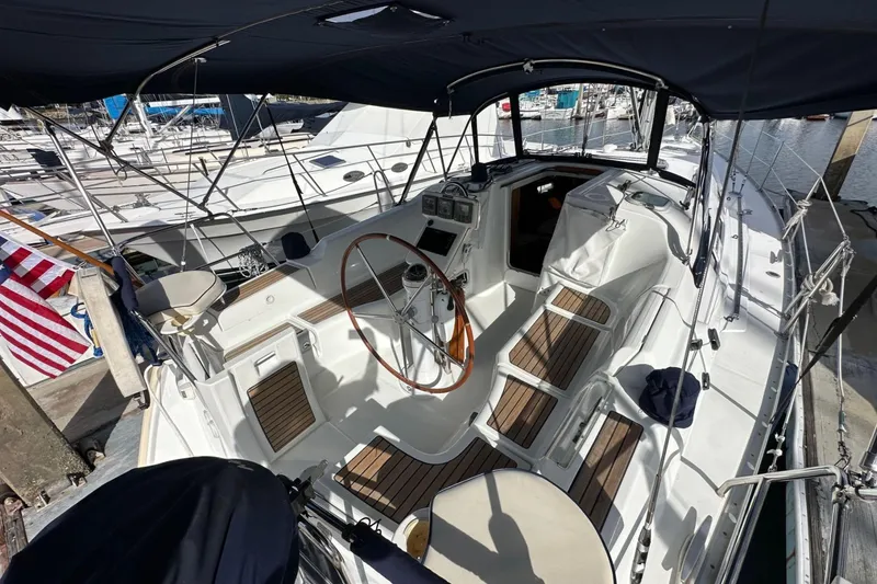Slide: The Image of 2005 Beneteau Oceanis Clipper 373 sailboat cockpit with wooden accents and steering wheel. - 3