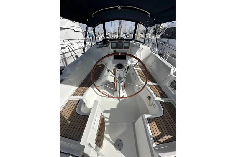 Slide: The Image of 2005 Beneteau Oceanis Clipper 373 cockpit with wooden accents and steering wheel. - 4