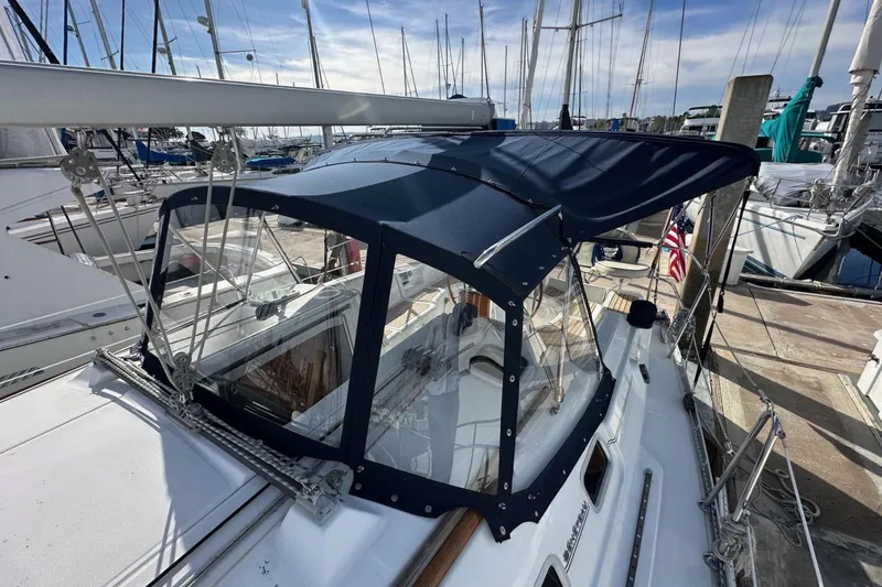 Slide: The Image of 2005 Beneteau Oceanis Clipper 373 sailboat docked with navy blue canopy. - 6