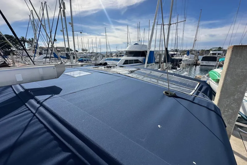 Slide: The Image of 2005 Beneteau Oceanis Clipper 373 sailboat docked in a marina under a sunny sky. - 7