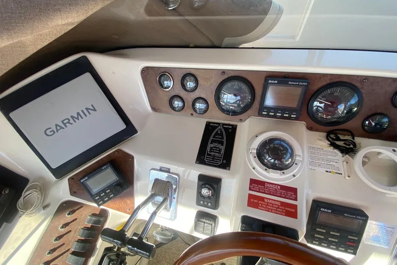 Slide: The Image of 1996 Sea Ray 440 Express Bridge helm with Garmin navigation and control instruments. - 15