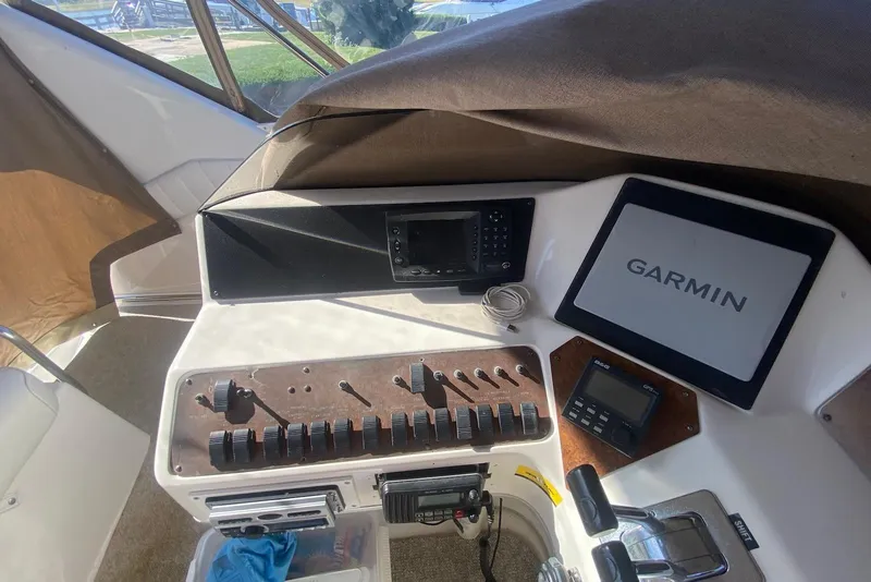 Slide: The Image of Control panel of 1996 Sea Ray 440 Express Bridge with Garmin navigation system. - 17