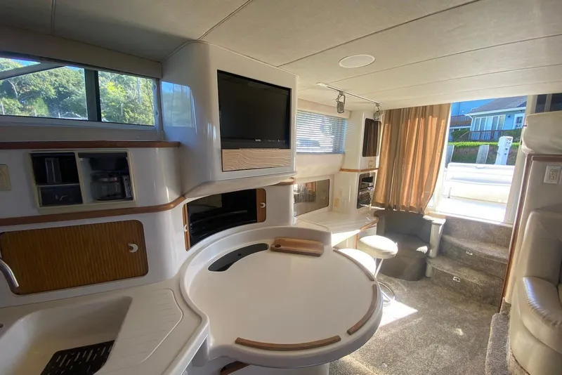 Slide: The Image of Interior of 1996 Sea Ray 440 Express Bridge yacht, featuring modern amenities and comfortable seating. - 25