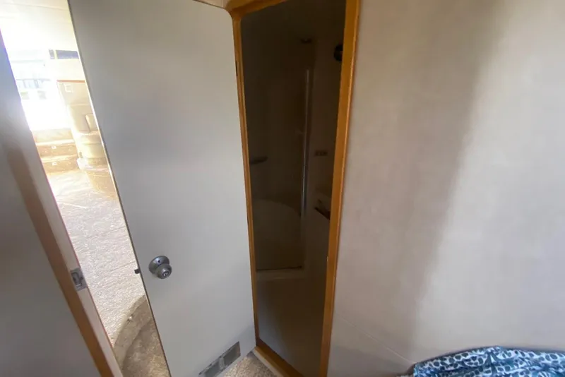 Slide: The Image of Interior view of 1996 Sea Ray 440 Express Bridge, showing a partially open door. - 31