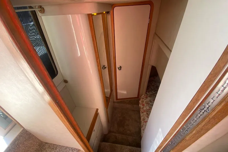 Slide: The Image of Interior of 1996 Sea Ray 440 Express Bridge, featuring stairs and cabin door. - 32