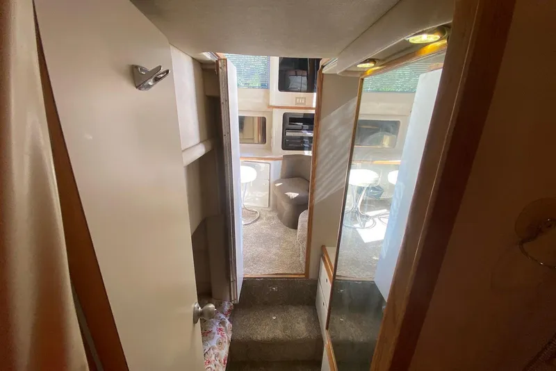 Slide: The Image of Interior view of 1996 Sea Ray 440 Express Bridge, featuring cozy seating and modern amenities. - 38