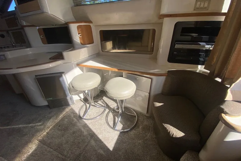 Slide: The Image of Interior of 1996 Sea Ray 440 Express Bridge with seating and modern amenities. - 39