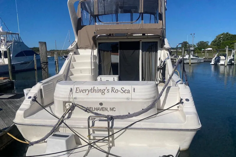 Slide: The Image of 1996 Sea Ray 440 Express Bridge docked, featuring "Everything's Ro-Sea" nameplate. - 4