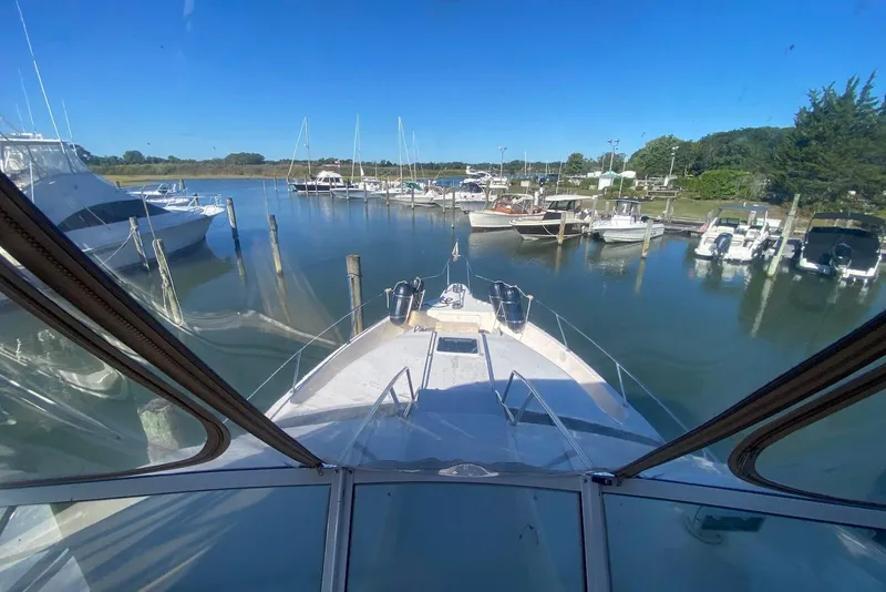 Slide: The Image of View from 1996 Sea Ray 440 Express Bridge, docked in a serene marina. - 9