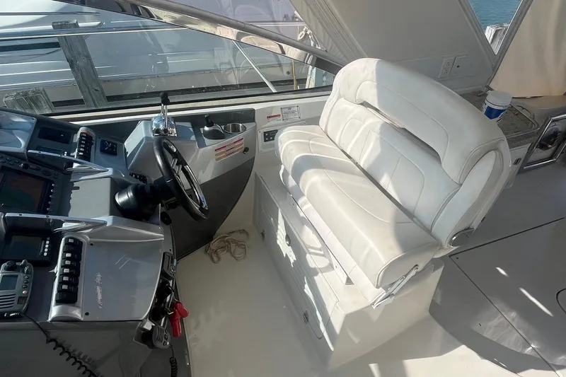 Slide: The Image of Cockpit of 2010 Monterey 400 Sport Yacht with white leather seating and control panel. - 15