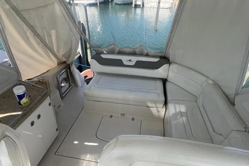Slide: The Image of Interior of 2010 Monterey 400 Sport Yacht with white seating and water view. - 16