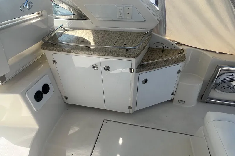 Slide: The Image of Interior of 2010 Monterey 400 Sport Yacht with granite countertop and storage cabinets. - 17