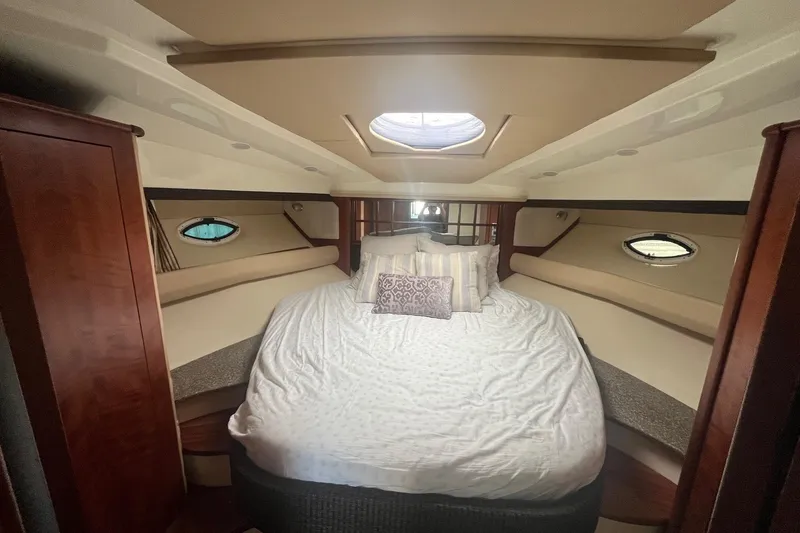 Slide: The Image of Luxurious cabin interior of 2010 Monterey 400 Sport Yacht with cozy bed and porthole windows. - 23
