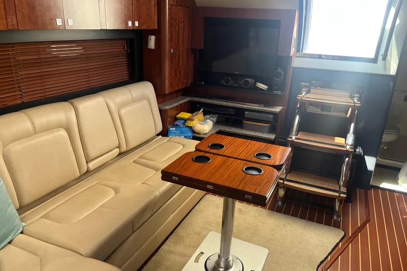 Slide: The Image of Interior of 2010 Monterey 400 Sport Yacht with beige seating and wooden table. - 24