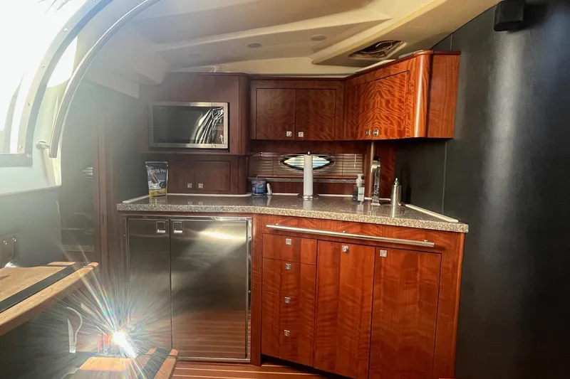 Slide: The Image of Luxurious kitchen interior of 2010 Monterey 400 Sport Yacht with wood cabinetry and modern appliances. - 25