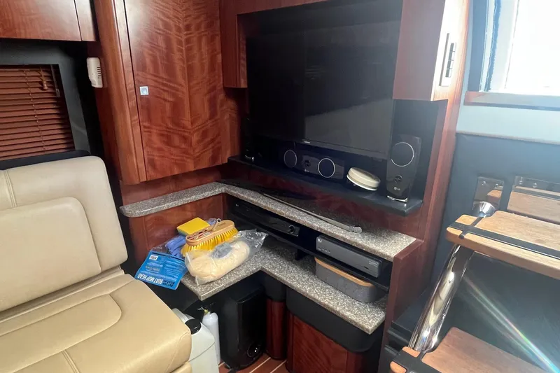 Slide: The Image of Interior of 2010 Monterey 400 Sport Yacht with entertainment system and storage shelves. - 26