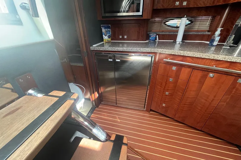 Slide: The Image of Luxurious interior of 2010 Monterey 400 Sport Yacht with wood cabinetry and stainless steel appliances. - 28