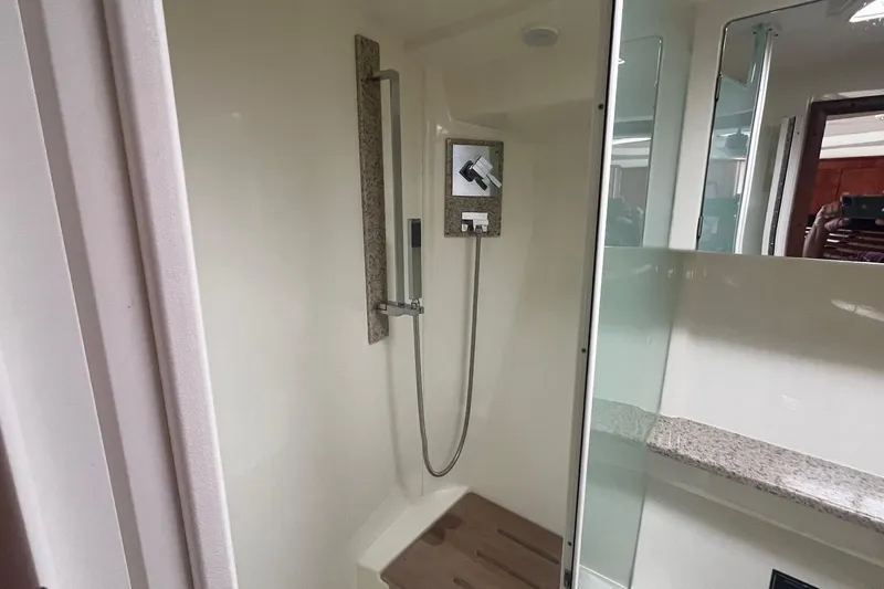 Slide: The Image of Shower area in 2010 Monterey 400 Sport Yacht with modern fixtures and granite accents. - 31