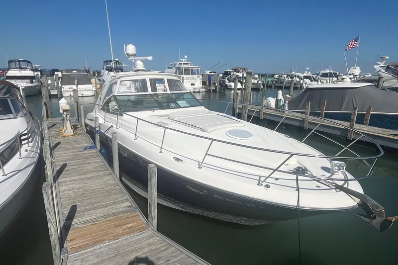 Slide: The Image of 2010 Monterey 400 Sport Yacht docked at marina under clear blue sky. - 4
