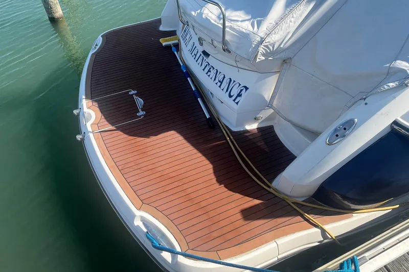 Slide: The Image of 2010 Monterey 400 Sport Yacht with teak swim platform, docked in calm waters. - 5