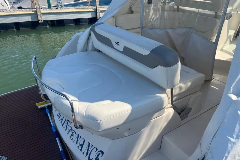 Slide: The Image of 2010 Monterey 400 Sport Yacht with white seating at marina dock. - 6