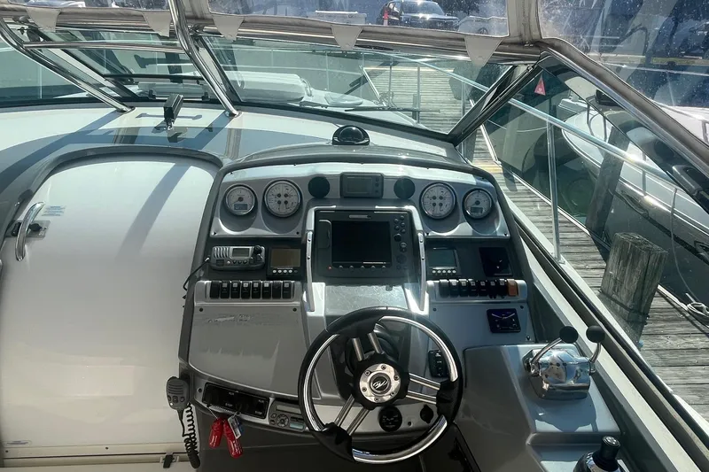 Slide: The Image of Cockpit of 2010 Monterey 400 Sport Yacht with steering wheel and control panel. - 7