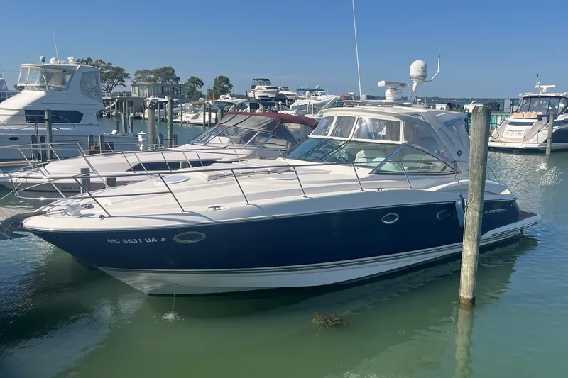 The Image of 2010 Monterey 400 Sport Yacht docked in a marina under clear blue skies. - 0