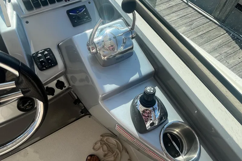 Slide: The Image of 2010 Monterey 400 Sport Yacht helm with controls and steering wheel. - 8