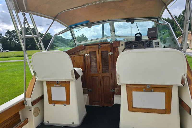Slide: The Image of 1989 Hinterhoeller Limestone boat interior with wooden accents and steering console. - 17