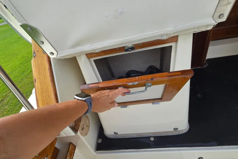 Slide: The Image of Person opening storage compartment on 1989 Hinterhoeller Limestone boat deck. - 19