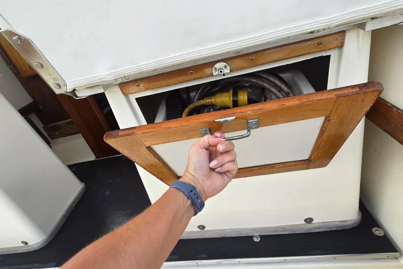 Slide: The Image of Hand opening storage compartment on 1989 Hinterhoeller Limestone boat. - 21