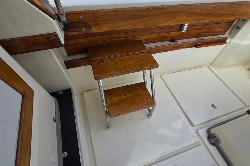 Slide: The Image of 1989 Hinterhoeller Limestone boat interior with wooden steps and white flooring. - 22