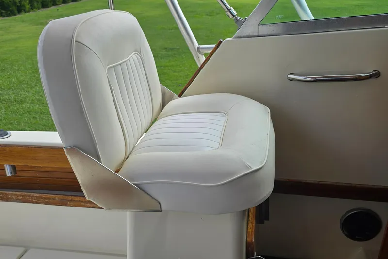 Slide: The Image of White captain's chair on 1989 Hinterhoeller Limestone boat, with green field view. - 24